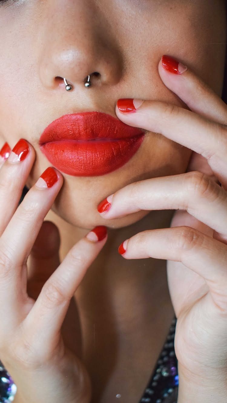 1920s Women Makeup: 9 Ideas for Lips, Eyes and Nails 6 Red nails with crescent nude tips and bright red matte lipstick on a woman