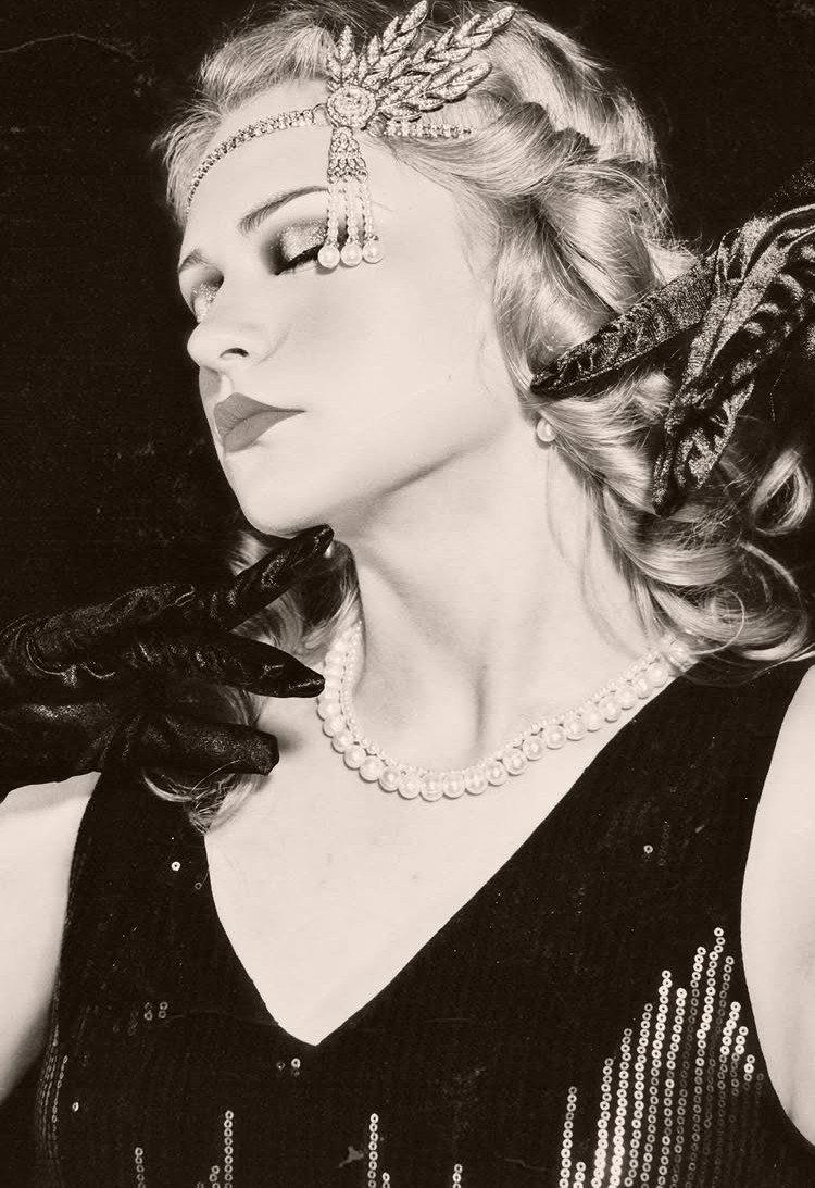 1920s Women Makeup: 9 Ideas for Lips, Eyes and Nails 2 Woman in 1920s flapper style with beaded headpiece and pearl necklace.