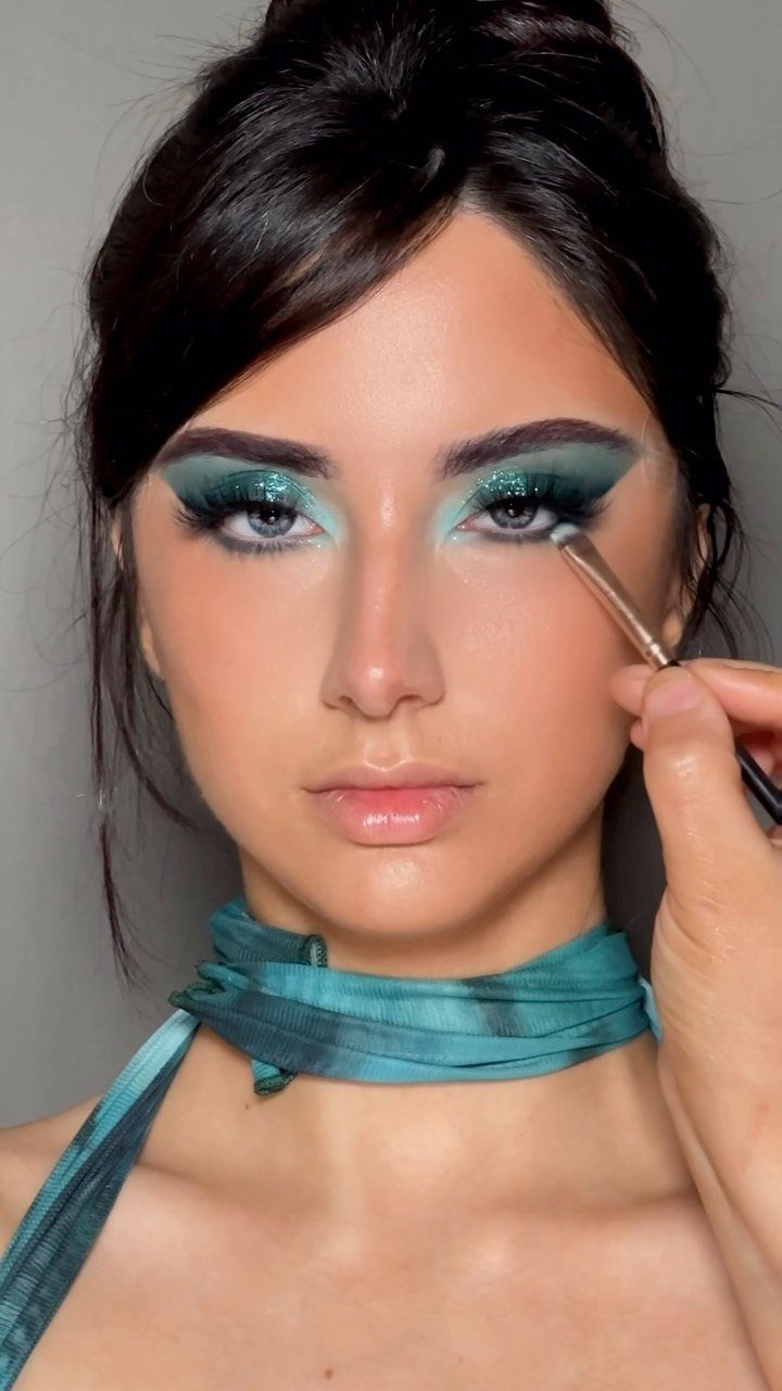 2006 Makeup Look Ideas: 6 Styles From Frosted Shadow to Glitter 1 Woman with shimmering icy blue-green eyeshadow and a matching teal neck scarf.