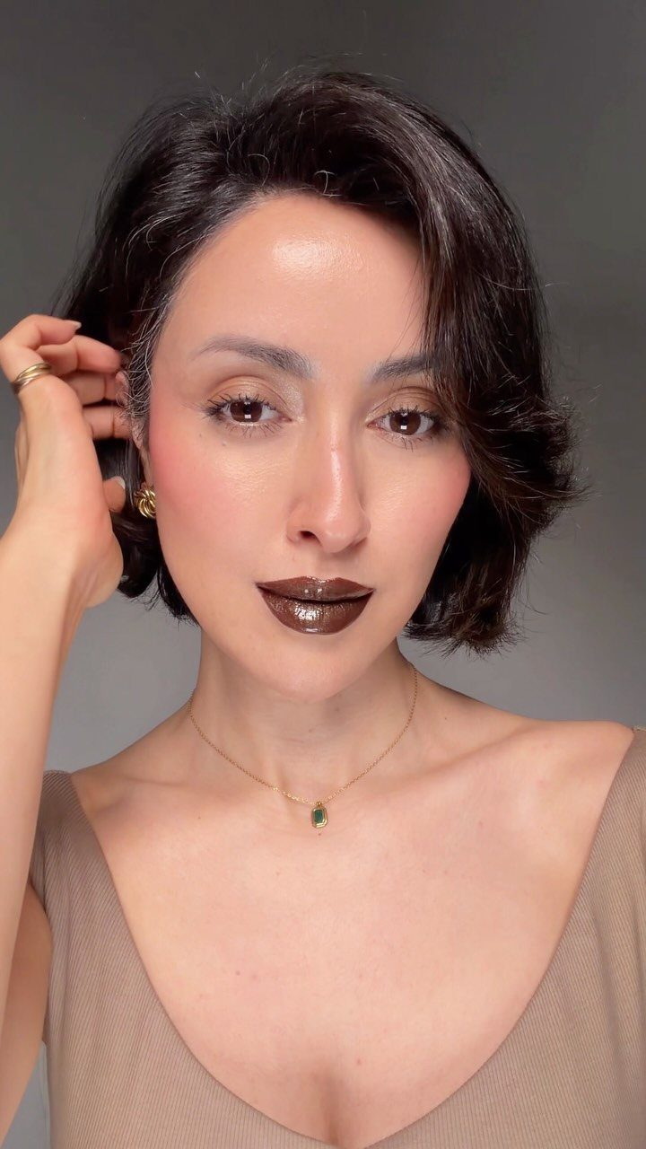 2006 Makeup Look Ideas: 6 Styles From Frosted Shadow to Glitter 5 Woman with short dark hair wearing metallic brown lipstick and neutral makeup.
