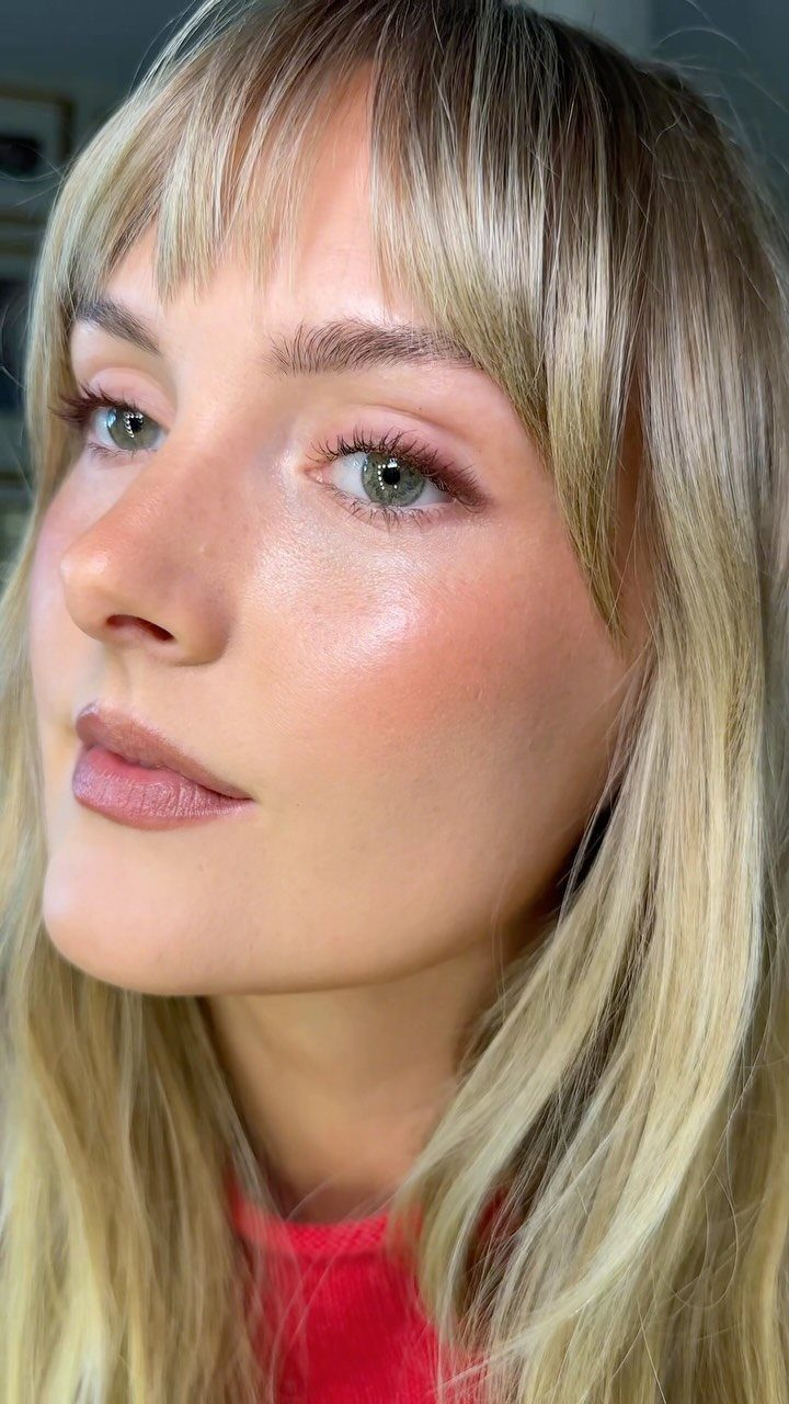 Woman with blonde hair wearing soft pink makeup and matte nude lips.