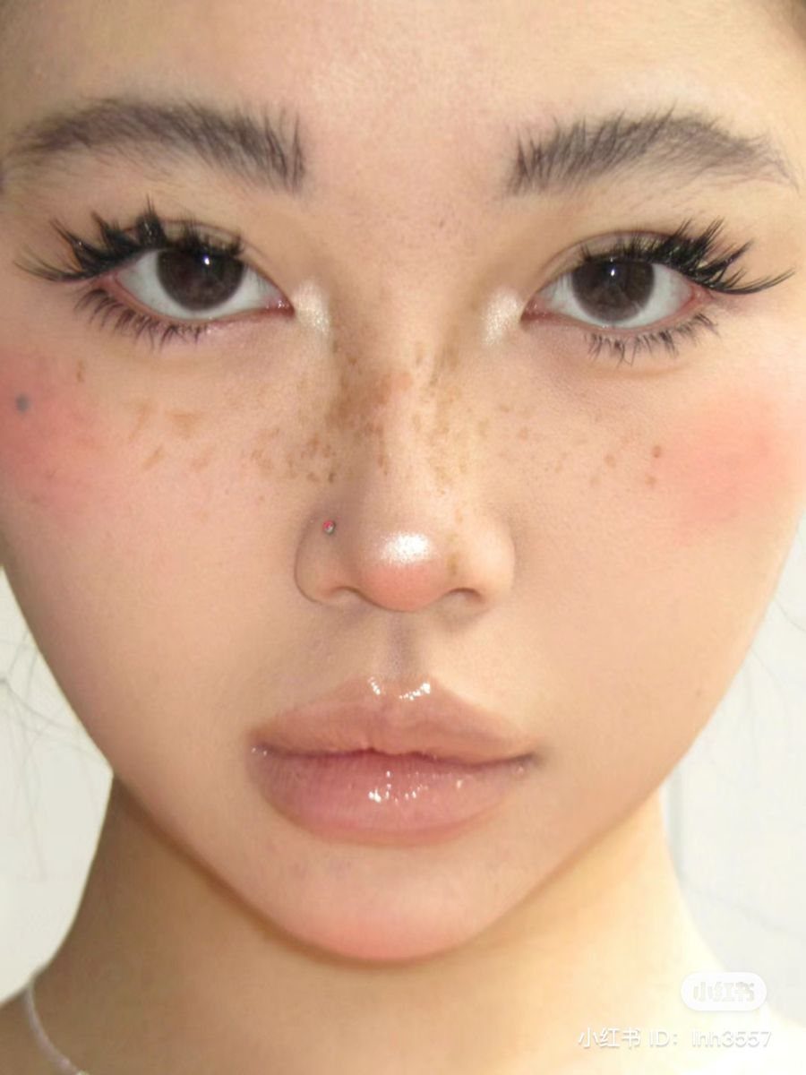 Bunny Face Makeup: 8 Ideas for Whiskers, Blush and More 7 Person's face with brown faux freckles across the nose and pink blush.