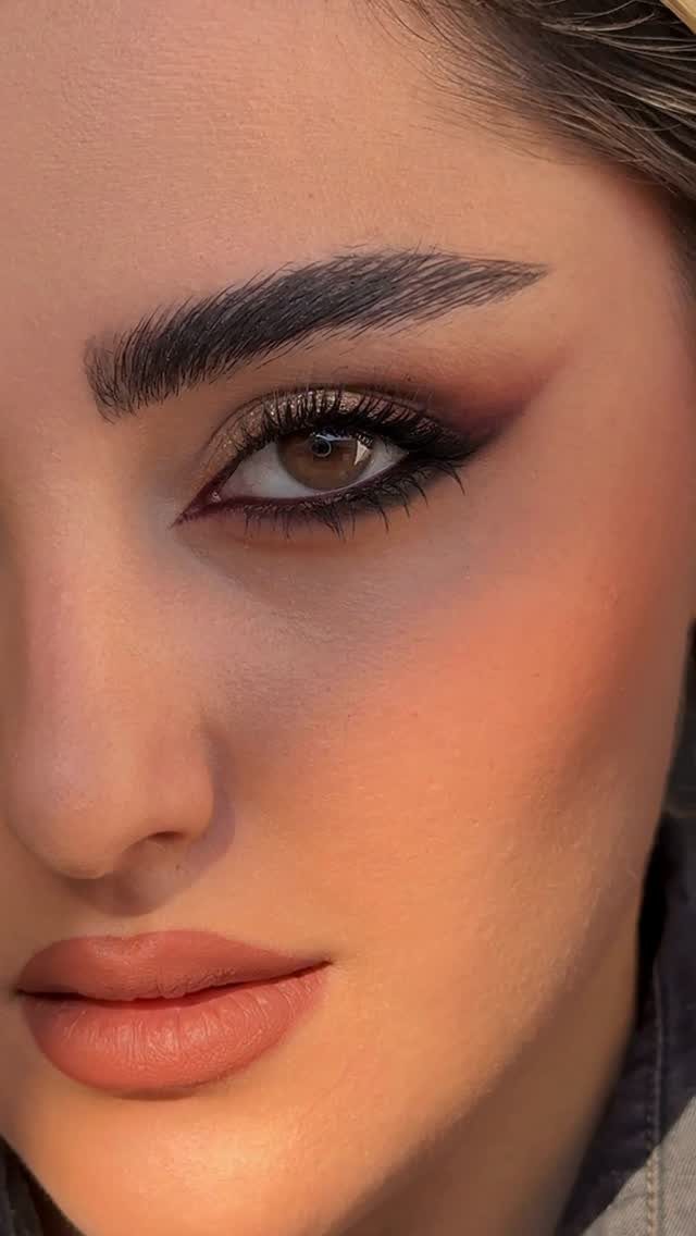 Daily Smokey Eye Ideas: 9 Looks for Every Day 6 Woman with a dark smokey eye makeup look and matte peach lipstick.
