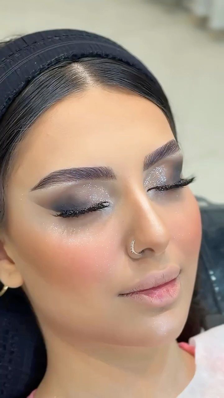 Daily Smokey Eye Ideas: 9 Looks for Every Day 9 Woman with shimmering silver and dark grey smokey eye makeup and nude lips.