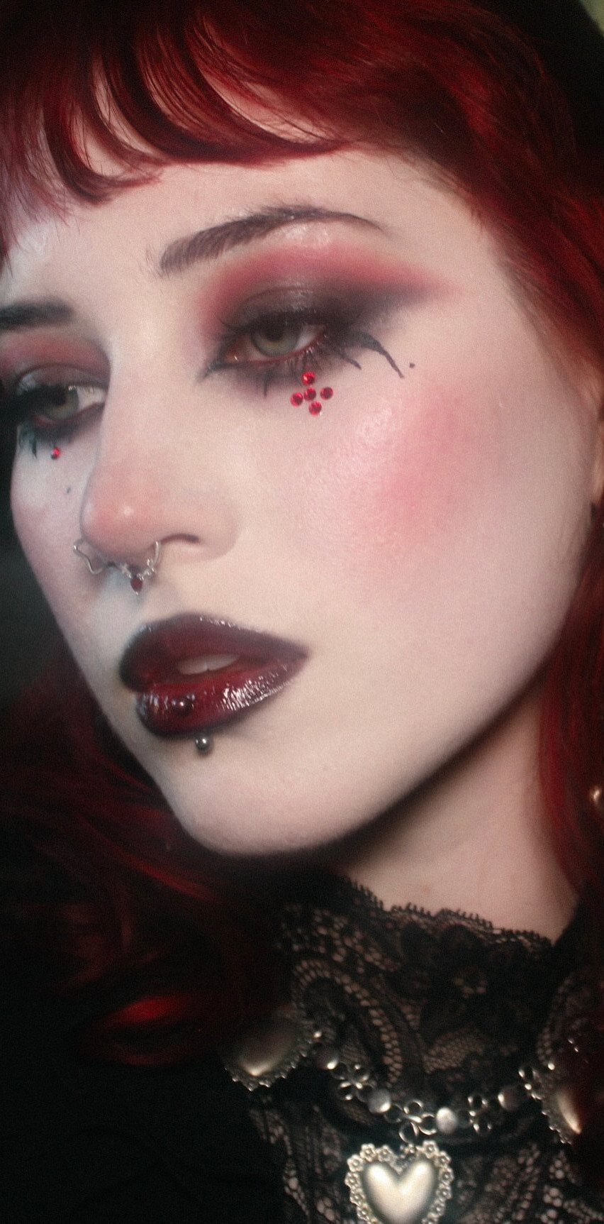 Person with red hair wearing dark emo makeup, burgundy lips, and black lace.