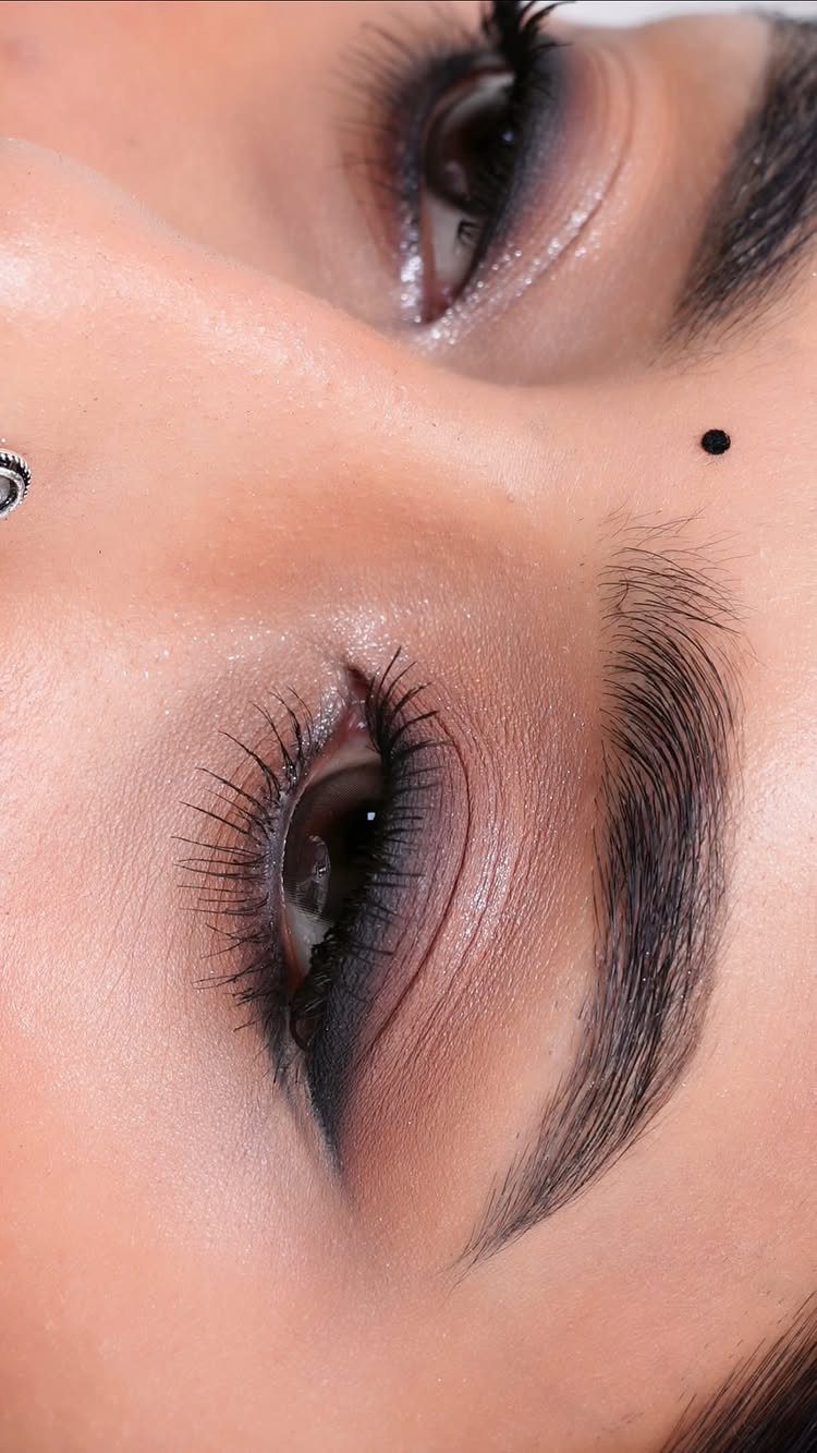 Close-up of eyes with natural brown and mauve eyeshadow and shimmering highlights.