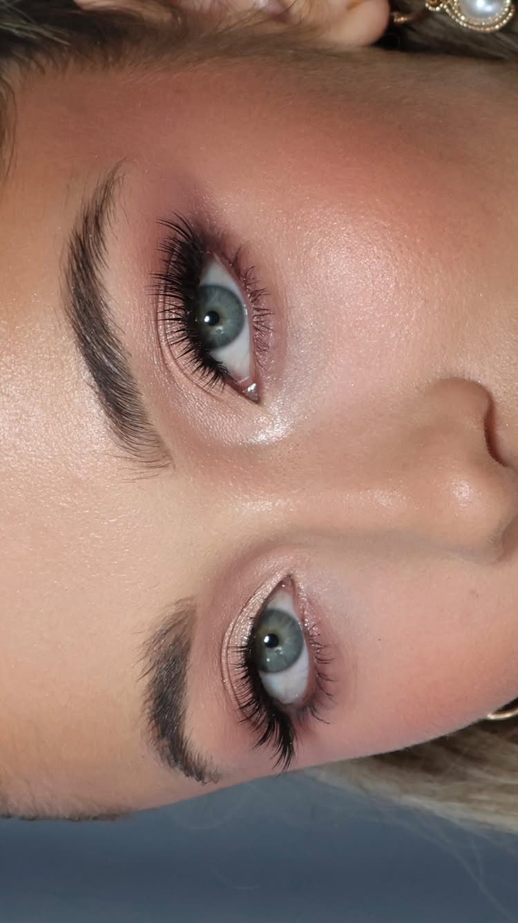 Close-up of eyes with soft pink natural eyeshadow and long dark lashes.