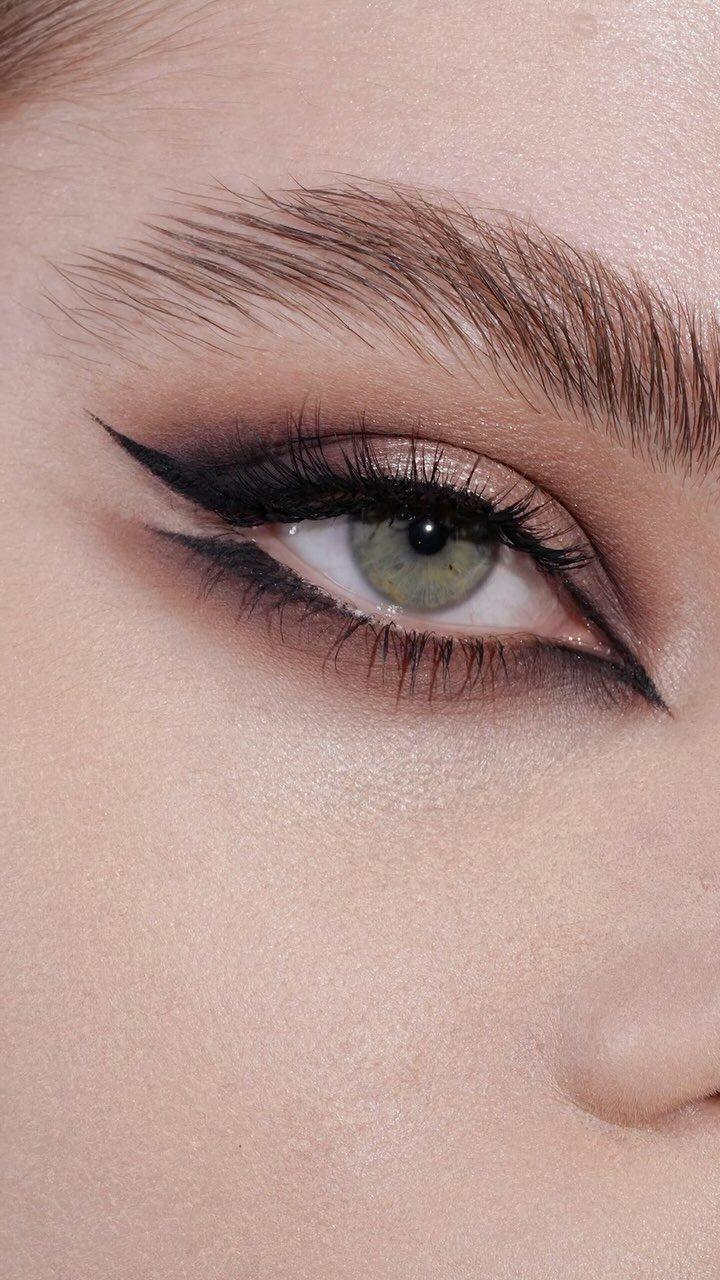 Eye with sharp black winged eyeliner on both upper and lower lash lines.