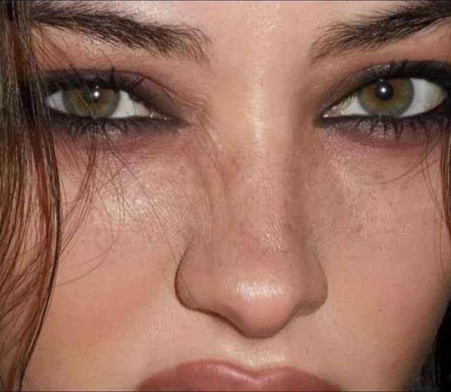 Close-up of eyes with dark, smudged eyeshadow and eyeliner on a person.