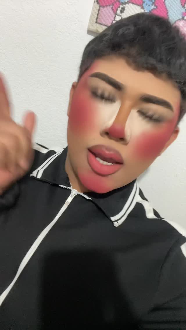Person with exaggerated red blush and contoured makeup creating a cartoonish facial appearance.