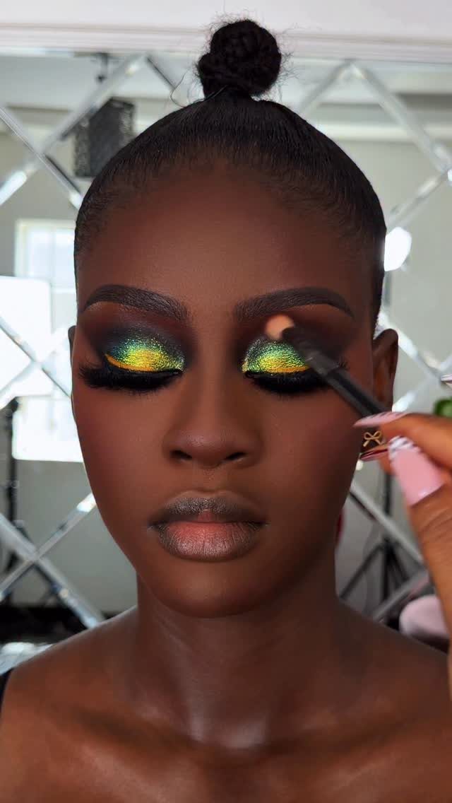 Glitter on Face Ideas: 19 Looks, From Freckles to Skulls 6 Woman with dark skin wearing bright acid green glitter eyeshadow on her eyelids