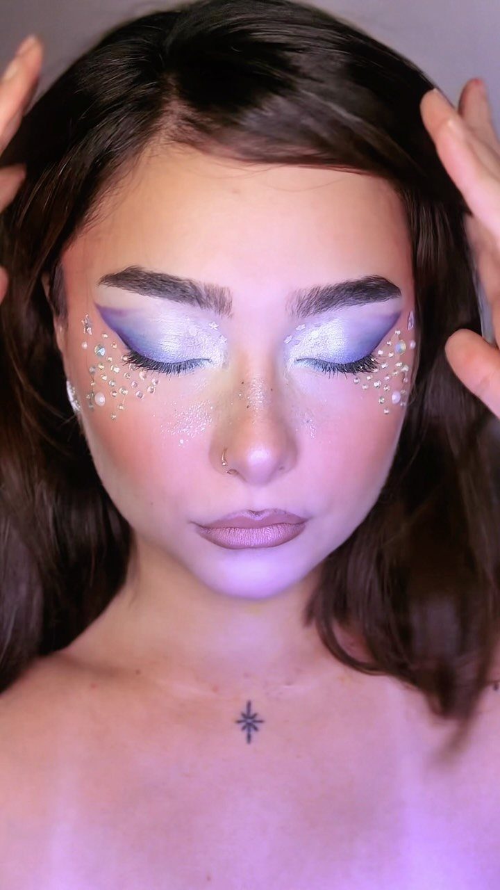 Glitter on Face Ideas: 19 Looks, From Freckles to Skulls 18 Woman with purple eyeshadow and white pearls and glitter on her cheeks
