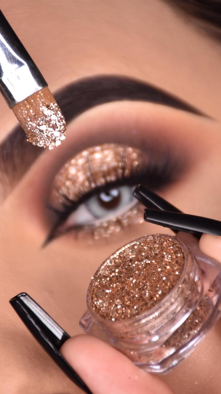 Glitter on Face Ideas: 19 Looks, From Freckles to Skulls 7 Eye with gold glitter eyeshadow and dark brown blending being applied with brush