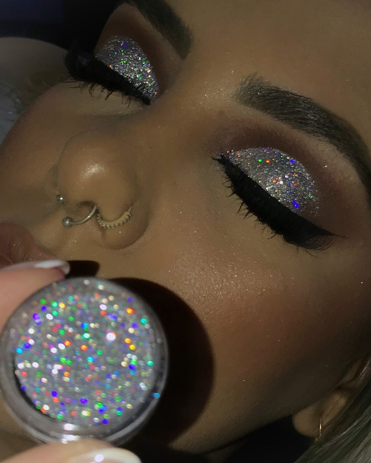 Glitter on Face Ideas: 19 Looks, From Freckles to Skulls 12 Person with holographic silver glitter eyeshadow and a pot of matching glitter.