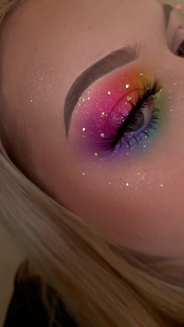 Glitter on Face Ideas: 19 Looks, From Freckles to Skulls 13 Rainbow colored eyeshadow with sparkling glitter accents on a person's eyelid