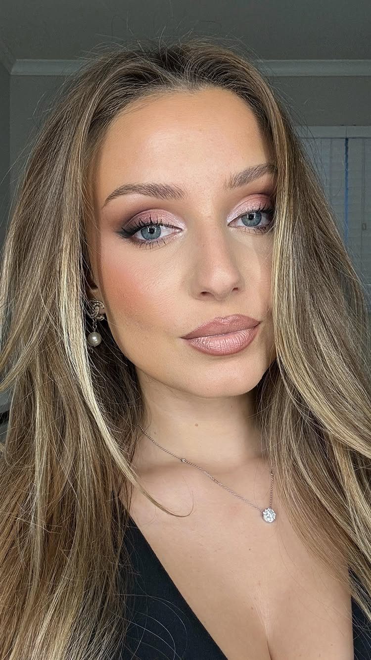Makeup for Pale Skin and Blue Eyes: 6 Looks to Try 3 Woman with blue eyes wearing shimmering pink and mauve eyeshadow and neutral makeup.