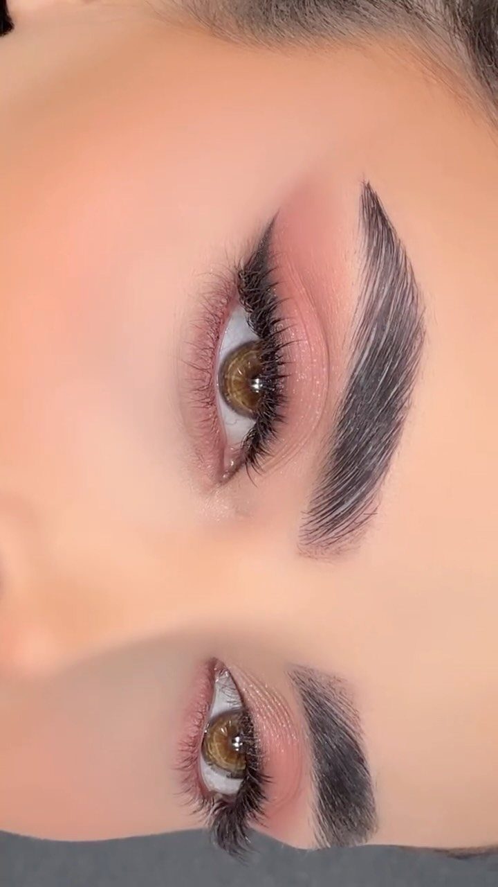 Eyes with winged eyeliner, long lashes, and pink eyeshadow on light skin.