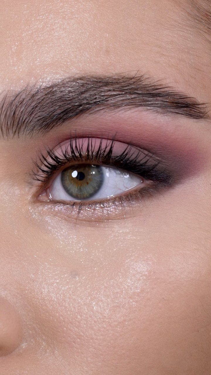 Eye with pink eyeshadow and shimmery light highlight in the inner corner.