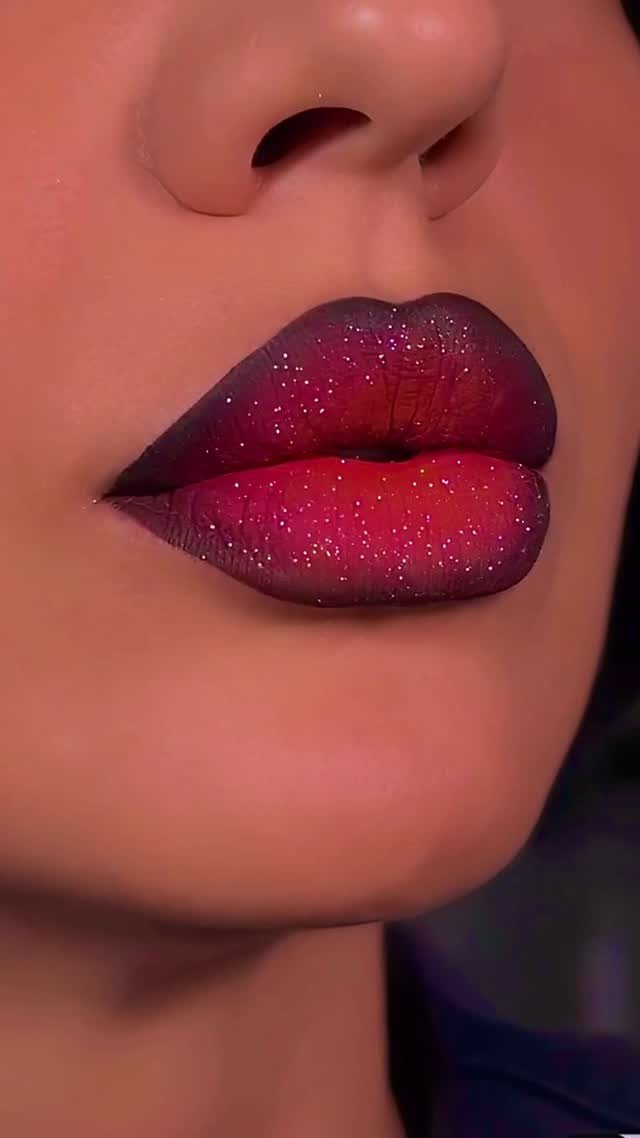 Lips with a purple and red glitter gradient makeup look close-up.