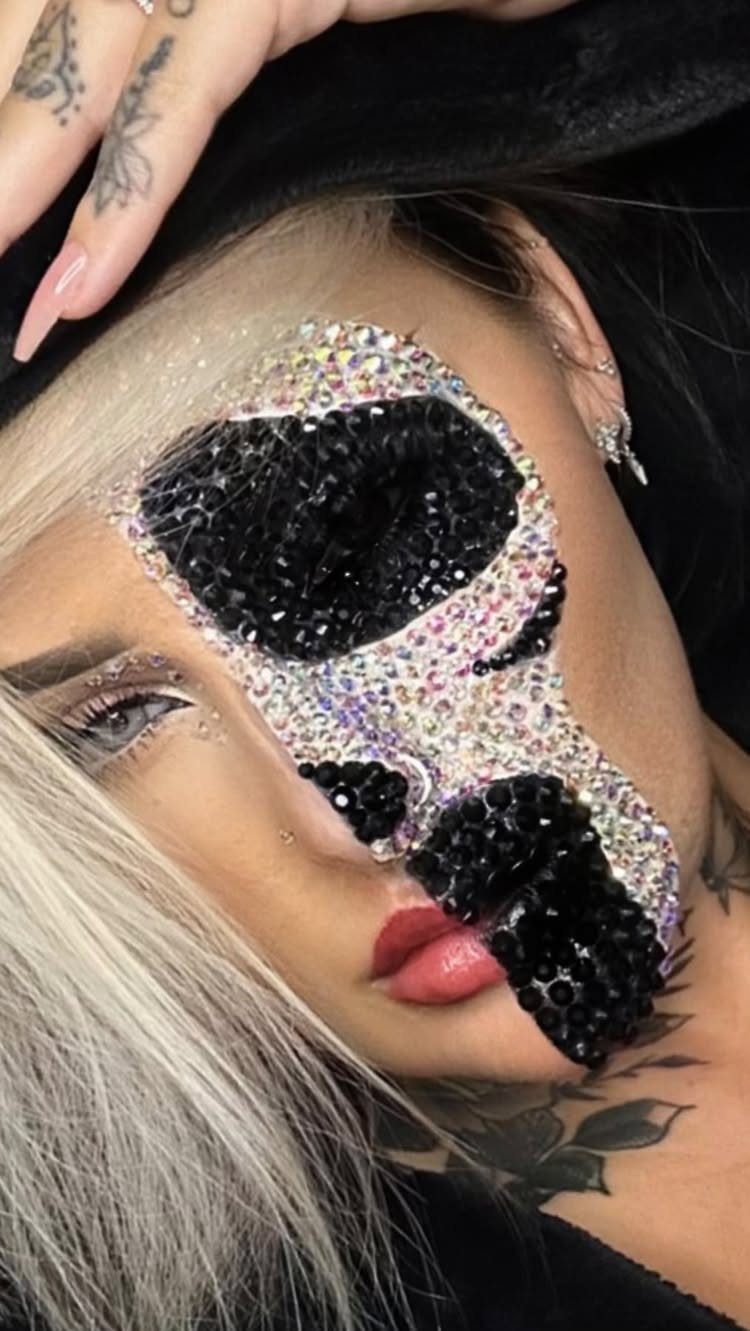 Person wearing a sparkling rhinestone eye patch design as pirate-themed makeup.