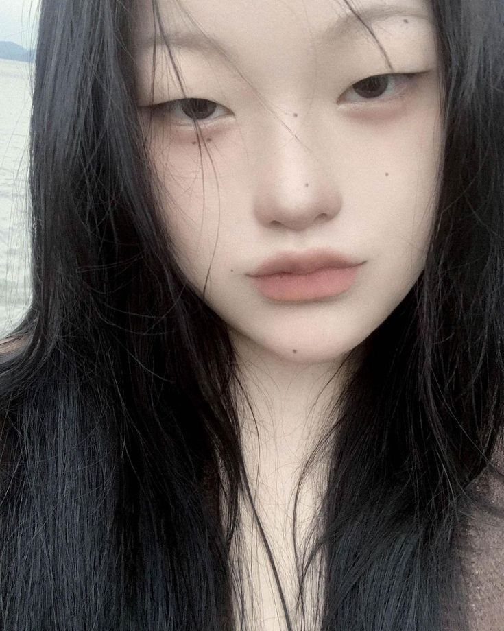 Pretty Monolid Eyes: 5 Makeup and Styling Ideas to Try 2 Person with long black hair and monolid eyes looking at the camera.