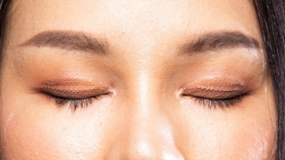 Pretty Monolid Eyes: 5 Makeup and Styling Ideas to Try 5 Closed monolid eyes with shimmering bronze eyeshadow and groomed brown eyebrows.