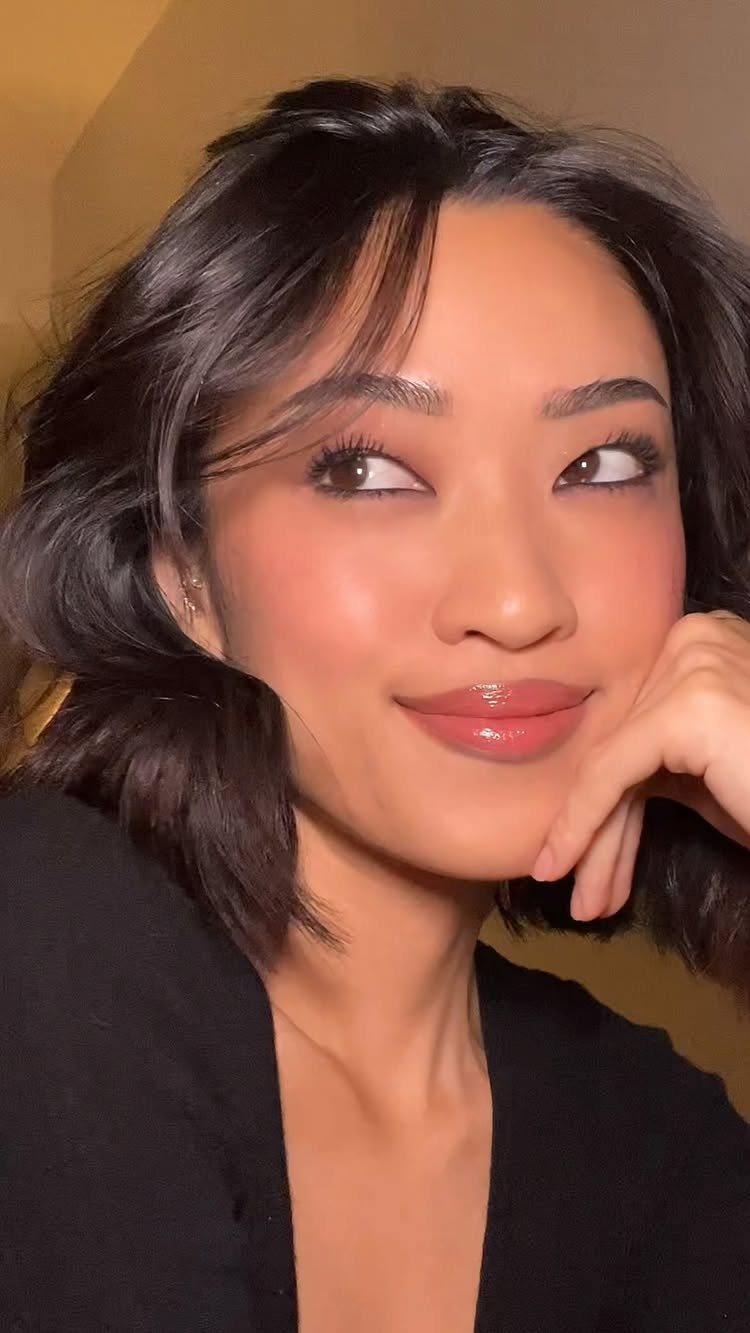 Pretty Monolid Eyes: 5 Makeup and Styling Ideas to Try 4 Woman with monolid eyes and glowing skin posing for a close-up portrait.