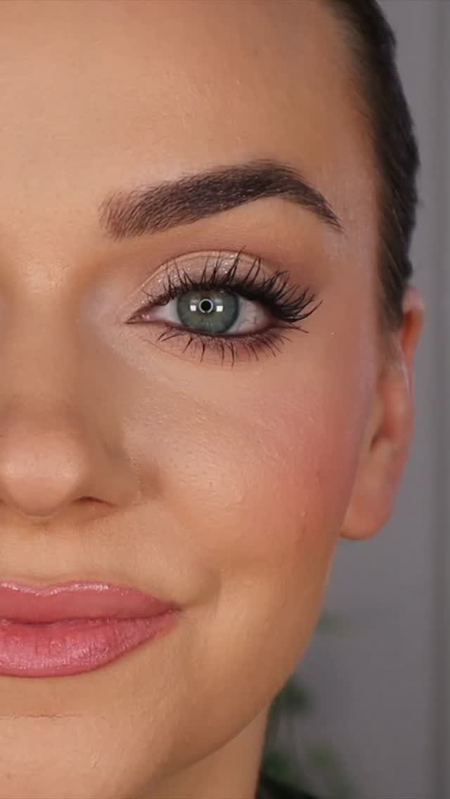 Woman with green eyes wearing smoky taupe eyeshadow and glossy pink lipstick
