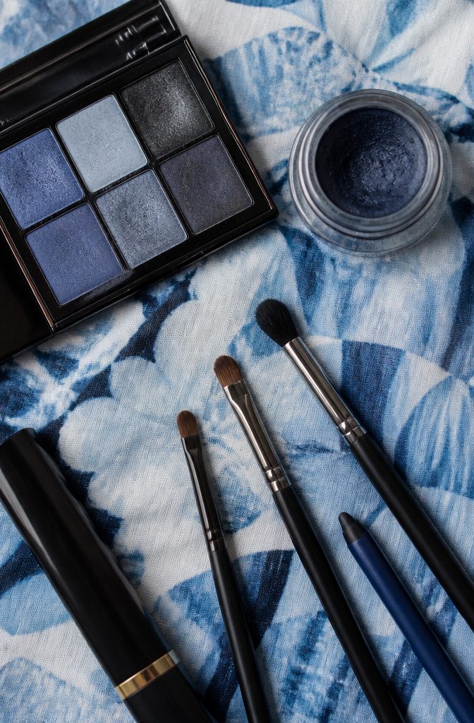 Three makeup brushes laid out for smokey eye application.