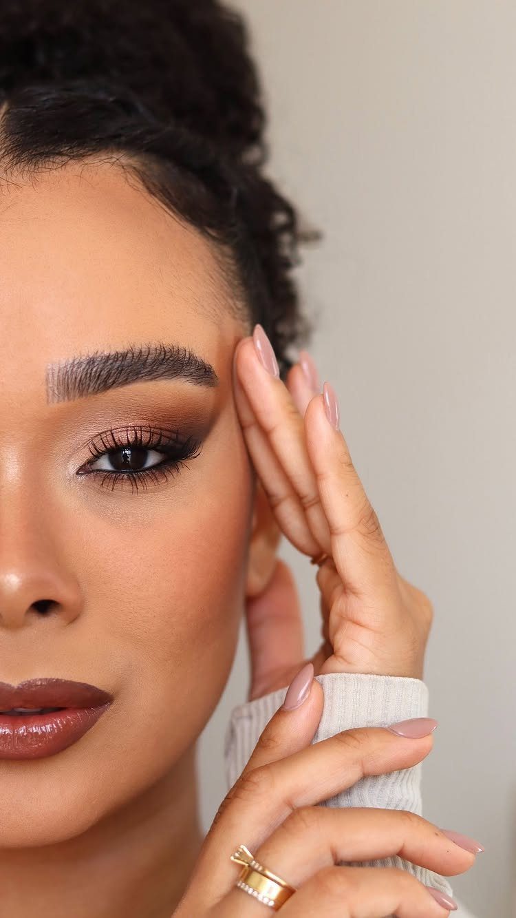Soft Sultry Makeup Ideas: 10 Looks for Day and Night 8 Woman with soft sultry makeup featuring bronze eyeshadow and glossy brown lips.