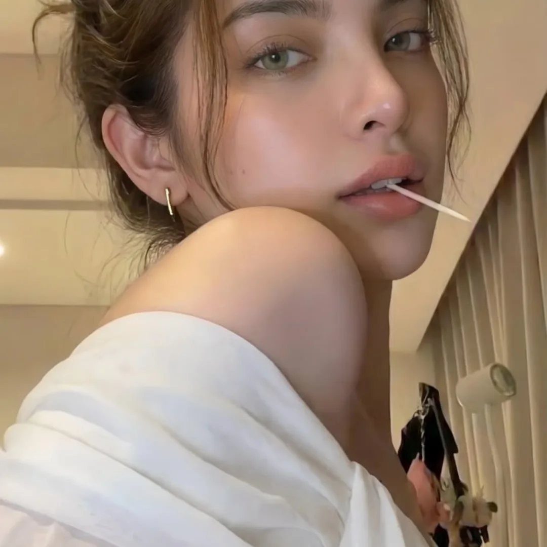 Soft Sultry Makeup Ideas: 10 Looks for Day and Night 7 Woman with glowing skin and neutral makeup posing in a white off-shoulder top.