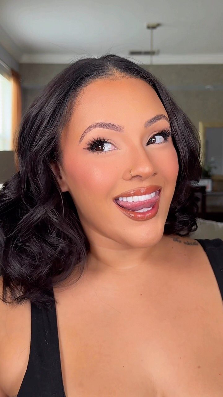 Square Face Shape Makeup Ideas: 6 Looks for Soft Angles 1 Woman with full face makeup and glossy lips smiling for a portrait.