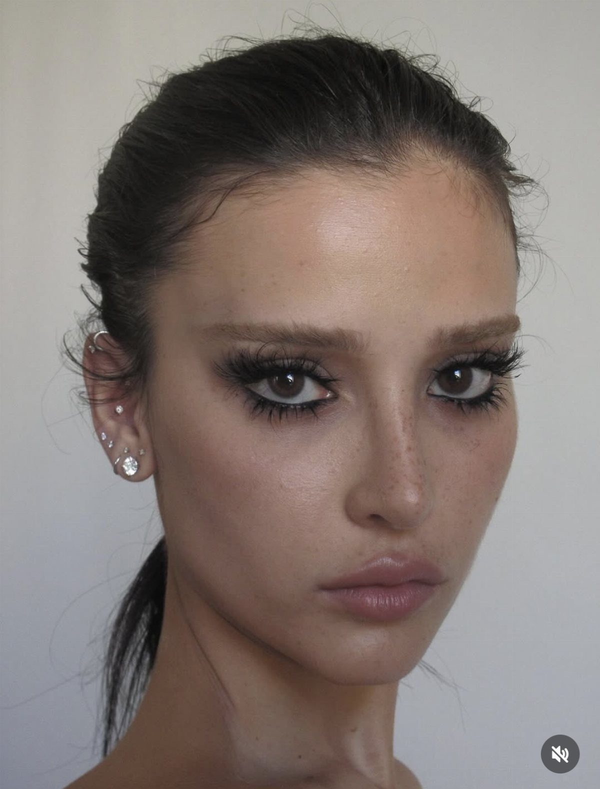 Woman with heavy black mascara and dark eyeliner on her eyes.