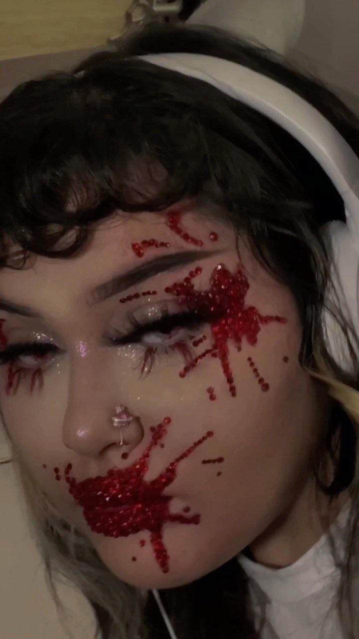 Vampire Eye Makeup Ideas: 8 Looks for Halloween Night 5 Person with red rhinestone makeup mimicking blood splatters around eyes and lips.