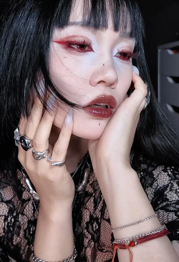 Vampire Eye Makeup Ideas: 8 Looks for Halloween Night 8 Person with red vampire eye makeup and dark red lips wearing black lace.